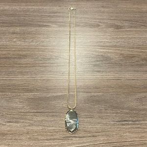 Long gold Kendra Scott necklace with large smoky stone